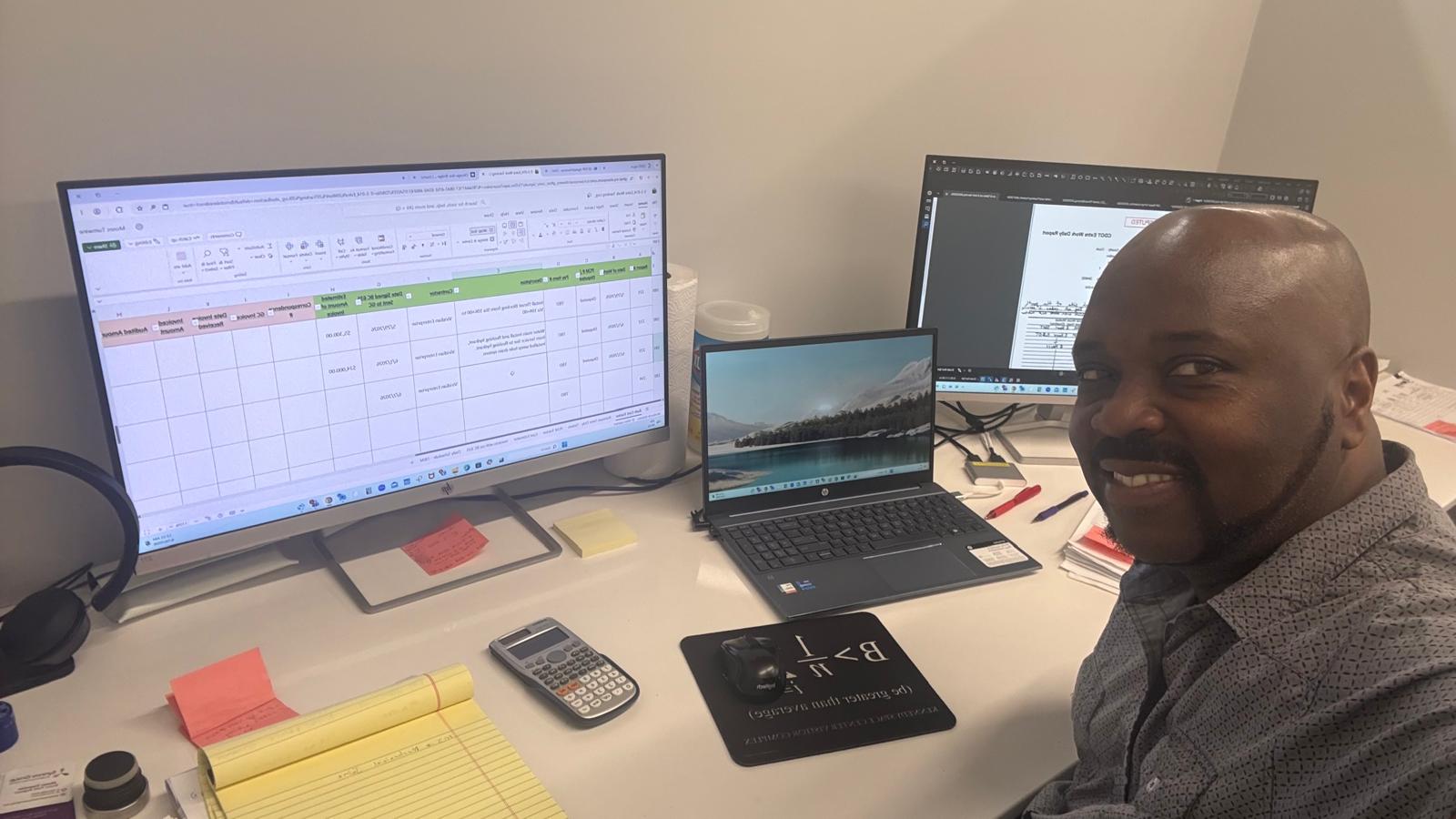 Reviewing engineering plans and project documentation at a workstation.